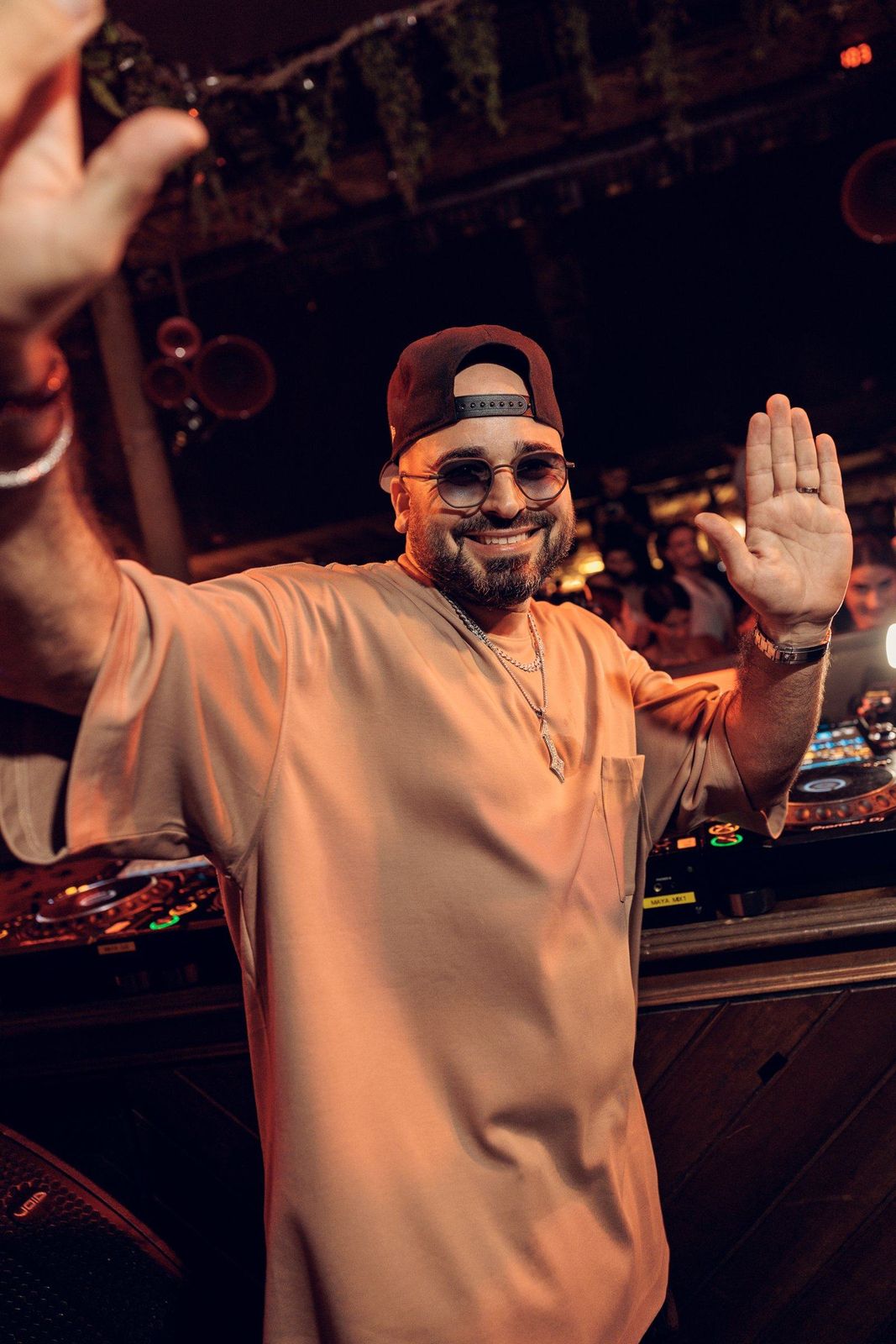 ERAN in white, waving to the crowd from the booth